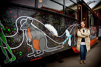 Dja Dja Wurrung Tram artist Natasha Carter standing next to her design
