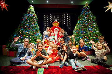 Children sitting with Santa as part of Bendigo Tramway's Santa Tram experience
