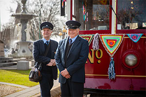 Tram Driver and conductor standing with tram at fountain